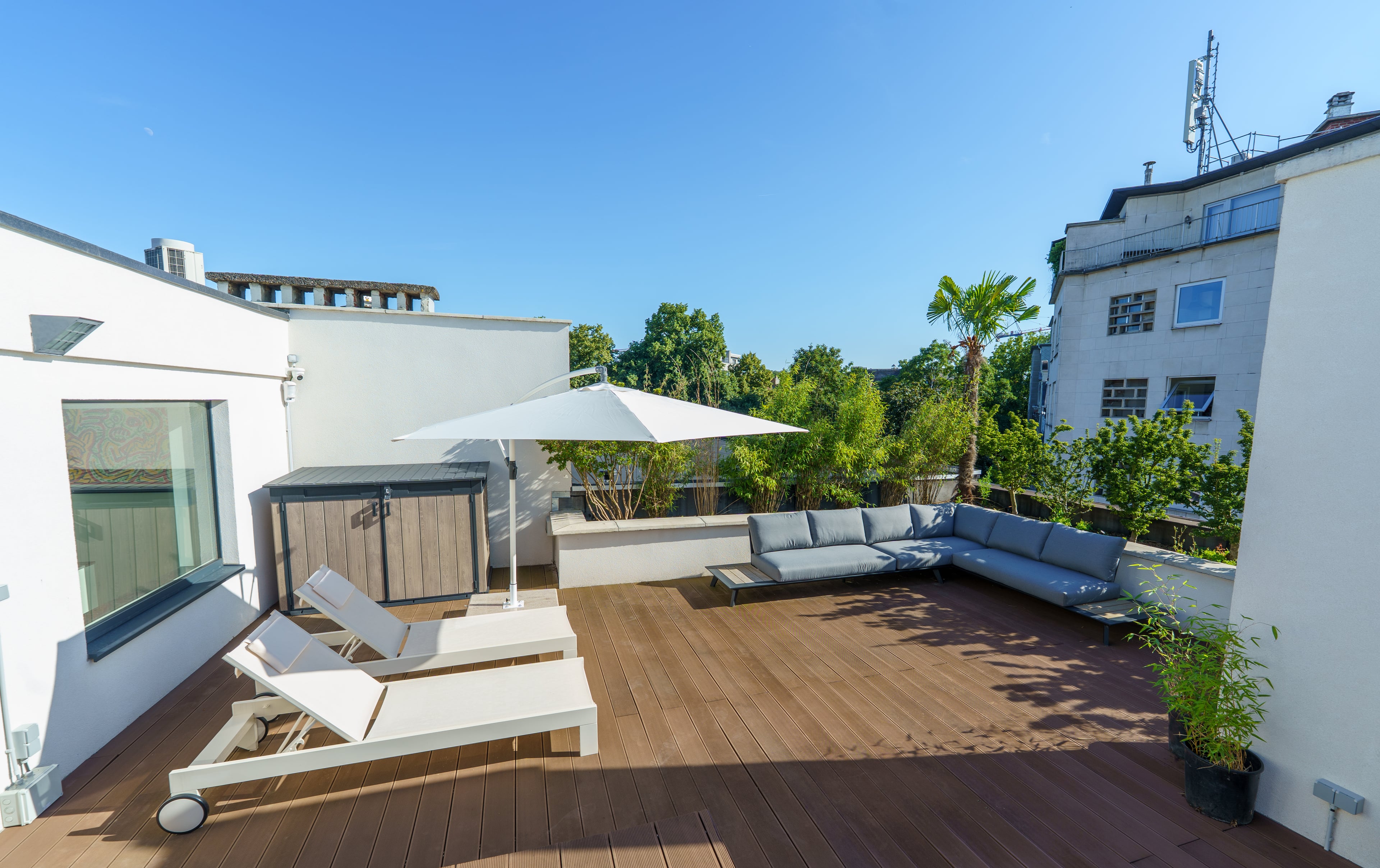 Rooftop terrace with sun loungers and an outdoor sofa at Maison Lemonnier in Uccle, Brussels